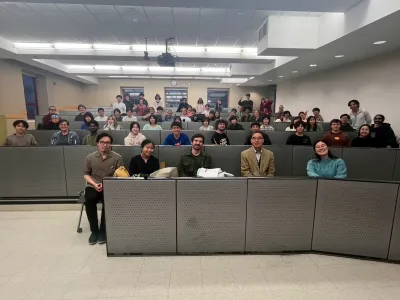 A classroom scene featuring a group of students attentively listening and participating  